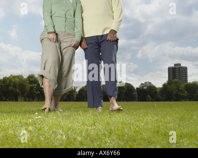 http://n450v.alamy.com/450v/ax6y66/elderly-couple-walking-bare-foot-in-the-park-ax6y66.jpg